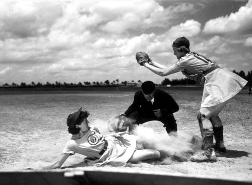All American Girls Professional Baseball League player Marg Callaghan sliding into home plate as umpire Norris Ward watches: Opa-locka, Florida