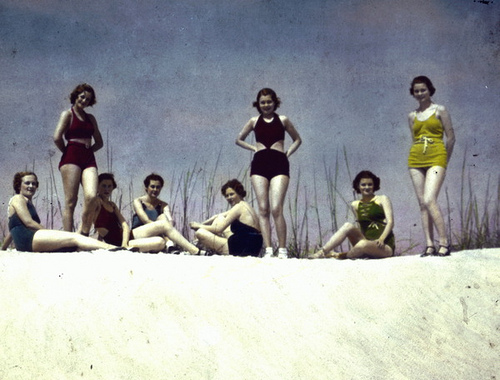 Young women posing in swimsuits on sand dune